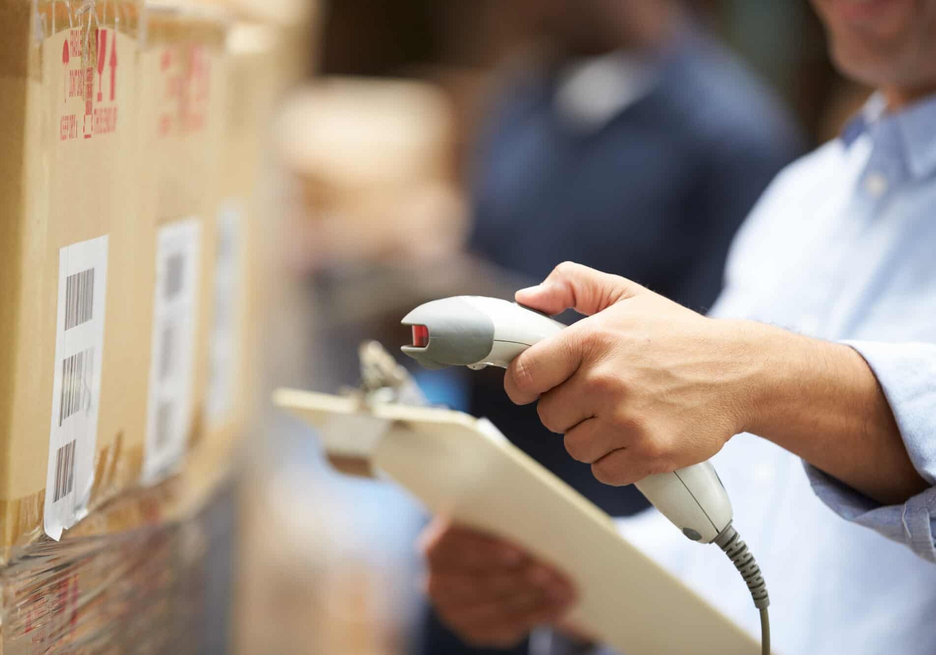 Worker Scanning Package In Warehouse